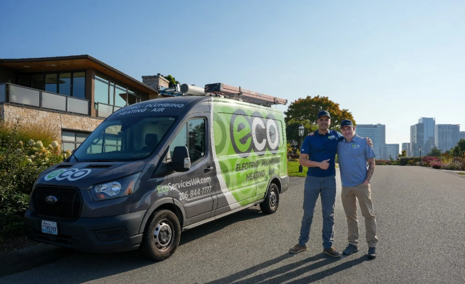 Two Eco technicians beside a branded Eco Electric, Plumbing, Heating & Air service van
