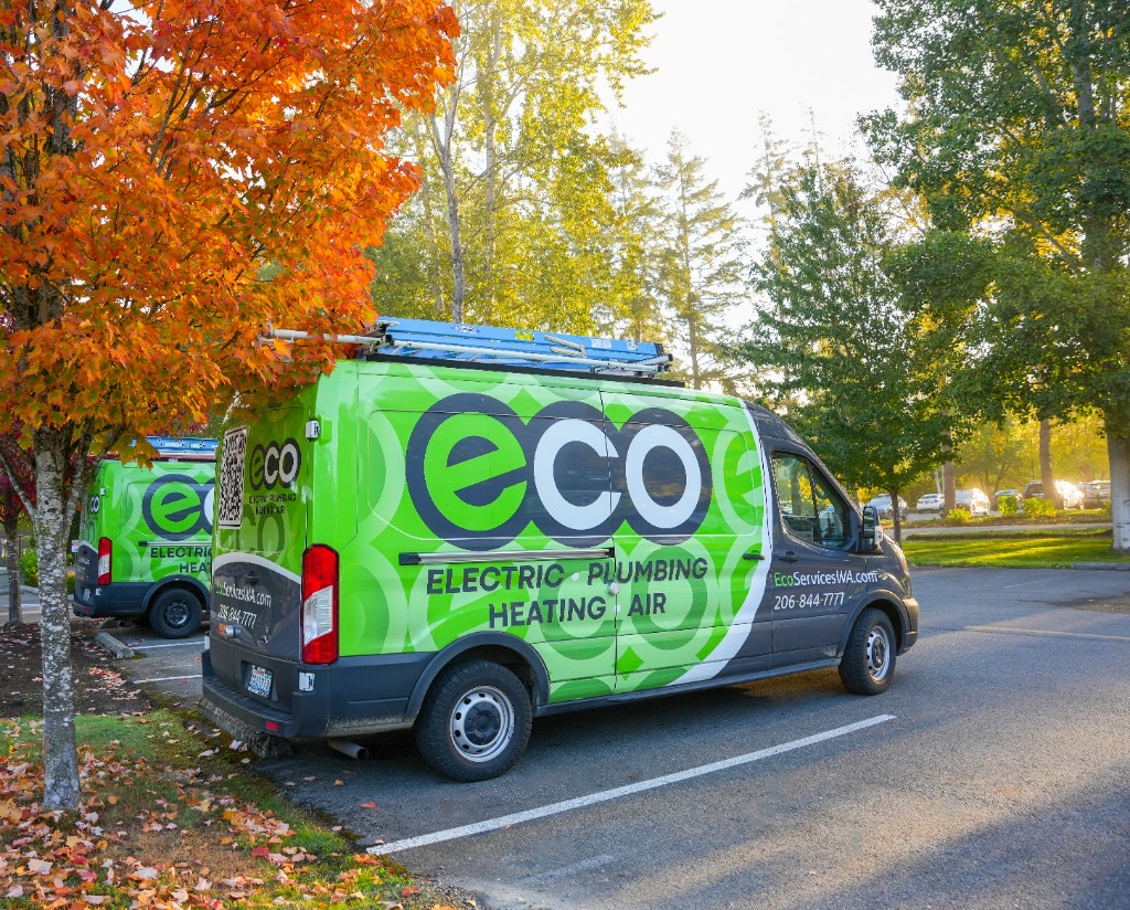 Cory, founder of Eco Electric, Plumbing, Heating & Air, with the Eco crew and truck
