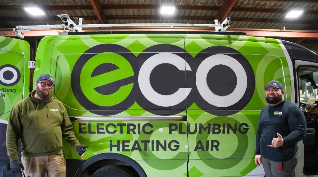 Eco technicians in front of a wrapped Eco service van