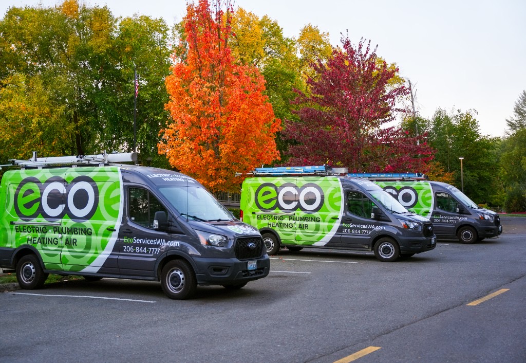 Eco technicians posing with a wrapped Eco service van