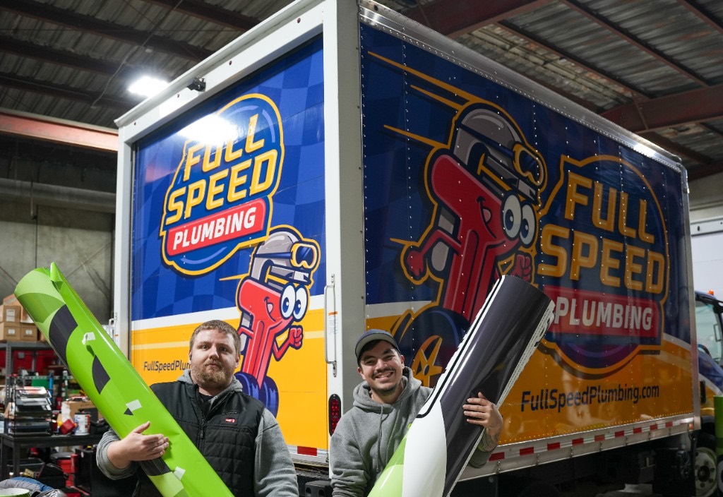 Eco technicians beside a green Eco Electric, Plumbing, Heating & Air van