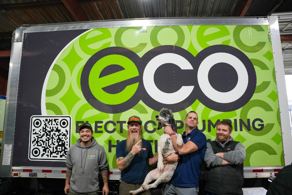 The Eco crew with the office dog by an Eco Electric, Plumbing, Heating & Air truck
