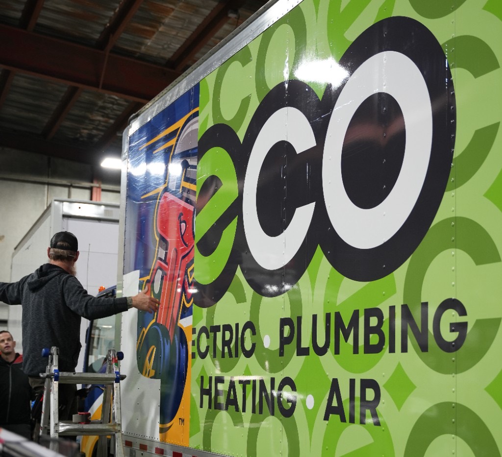 Wrapping an Eco Electric, Plumbing, Heating & Air box truck in the shop
