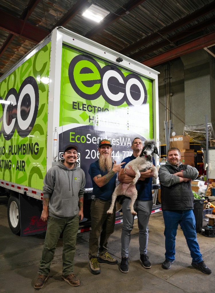 The Eco crew with the office dog in front of a wrapped Eco service truck